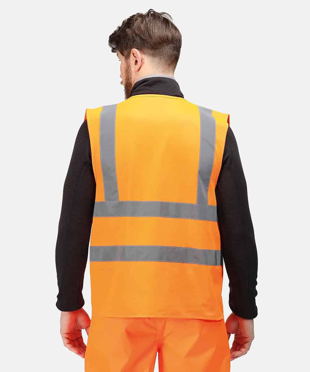 Man wearing a bright orange high visibility safety vest with reflective stripes.