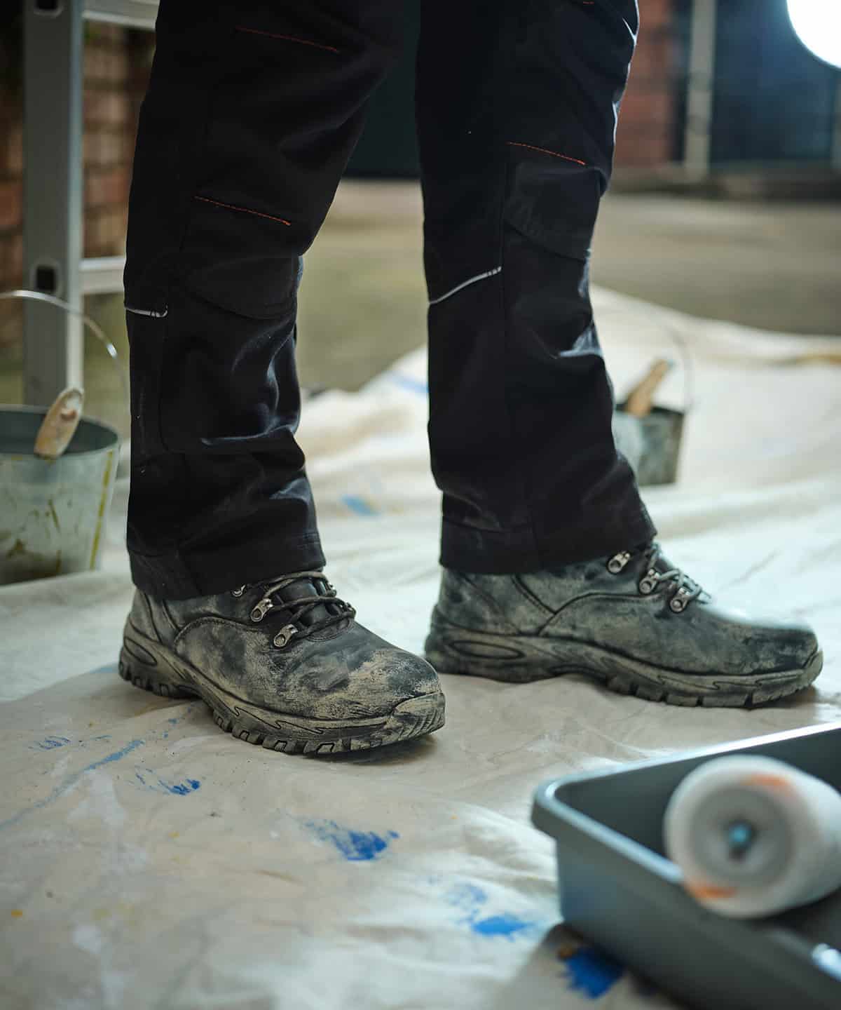 High visibility workwear with embroidered logo, safety work boots, durable personalisation for industrial, construction or trades.