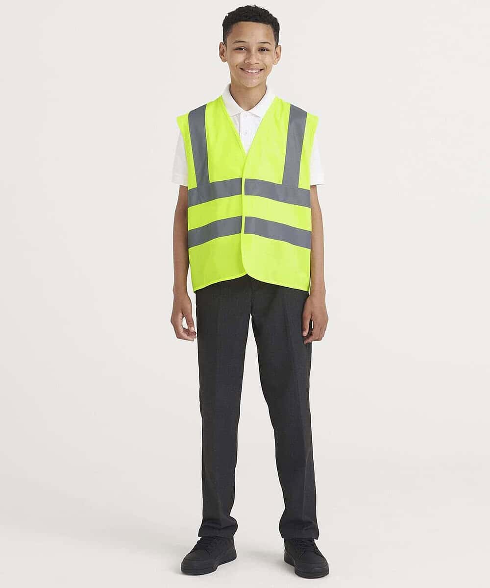 Child wearing high visibility yellow waistcoat with reflective stripes for safety.