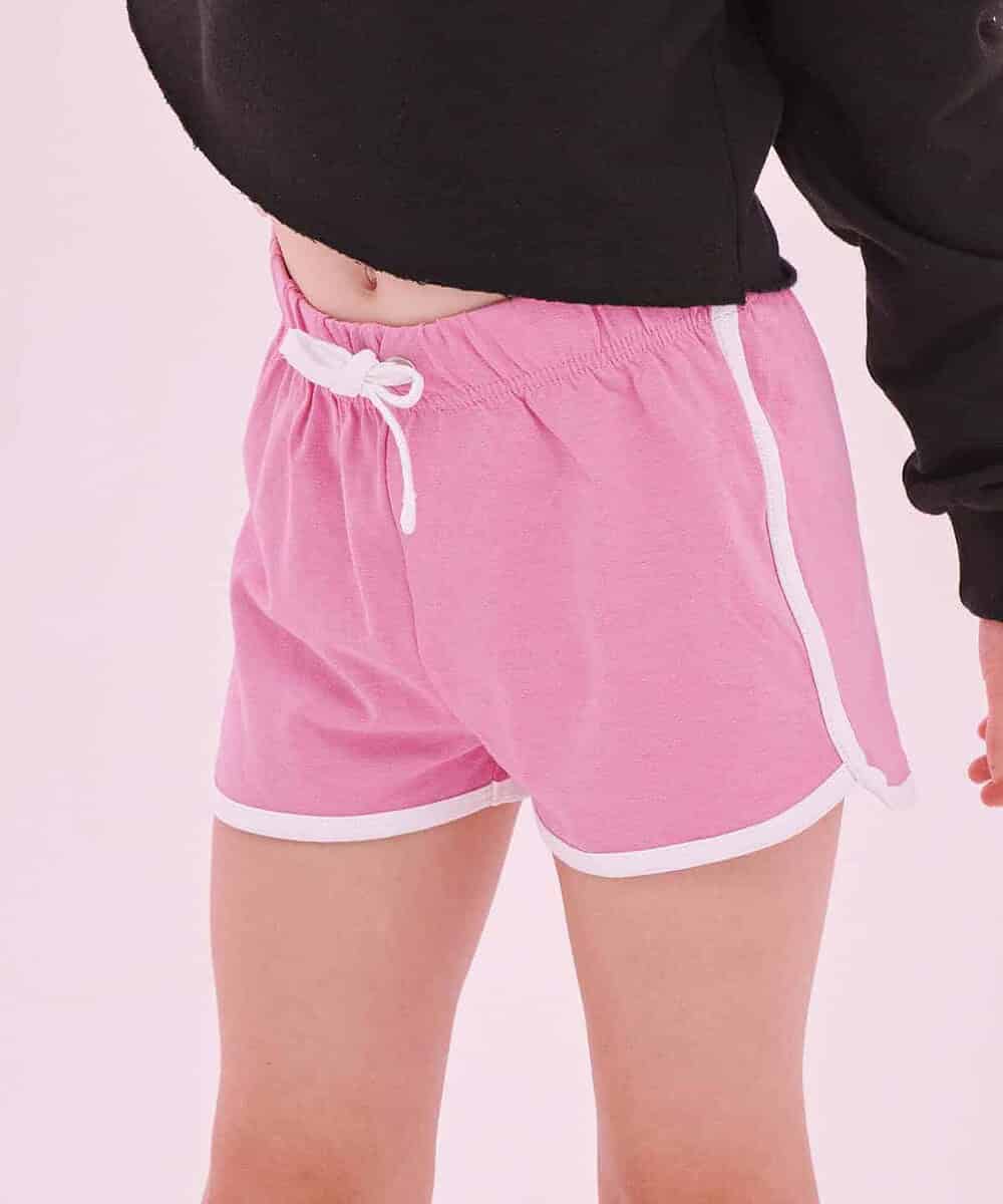 Child wearing pink retro shorts with white trim, casual sportswear for kids.