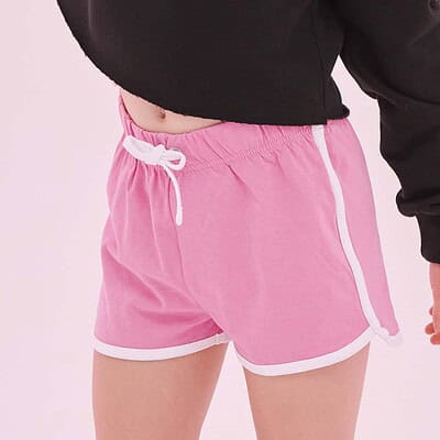 Child wearing pink retro shorts with white trim, casual sportswear for kids.