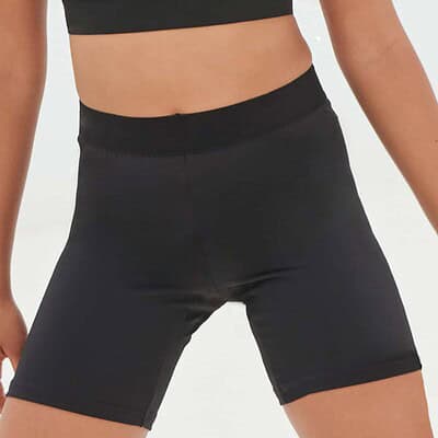 Close-up of black kids' cycling shorts, ideal for teamwear and sports activities.