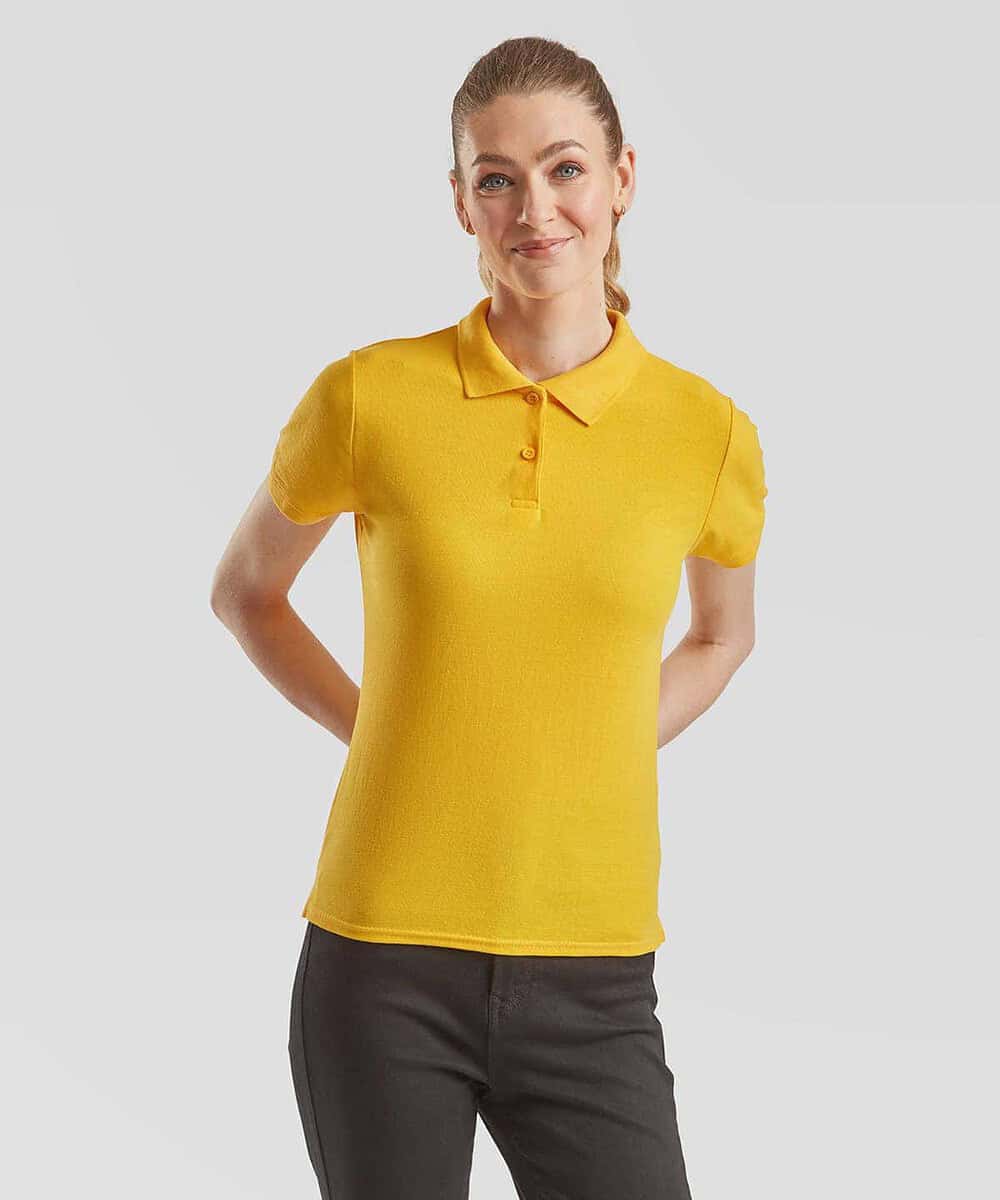 Woman wearing yellow embroidered polo shirt, professional team apparel.