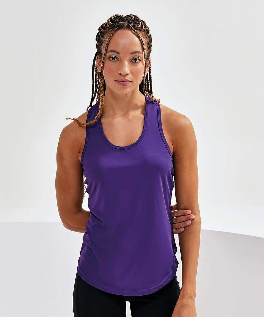 Woman wearing a purple Tridri® TR027 women's performance strap back vest.