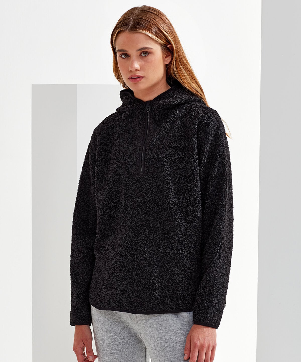 Warm black fleece hoodie with half-zip and adjustable hood, ideal for embroidered workwear and personalised uniforms for professional and casual wear.