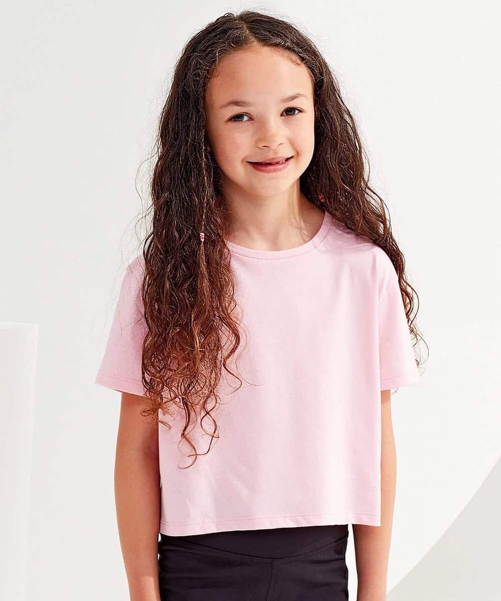 Child wearing pink Tridri® TR19B Kids Boxy Tee for school or casual wear.