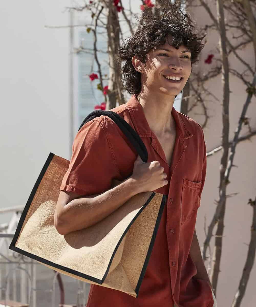 Embroidered jute shopper bag with black trim, ideal for branding and eco-friendly promotional giveaw.