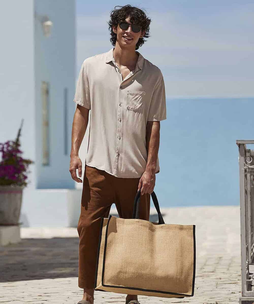Natural jute market shopper with black handles, ideal for branding and shopping.