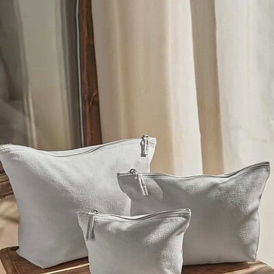 Embossed logo on a stylish white canvas accessory bag, perfect for branding and organisation.
