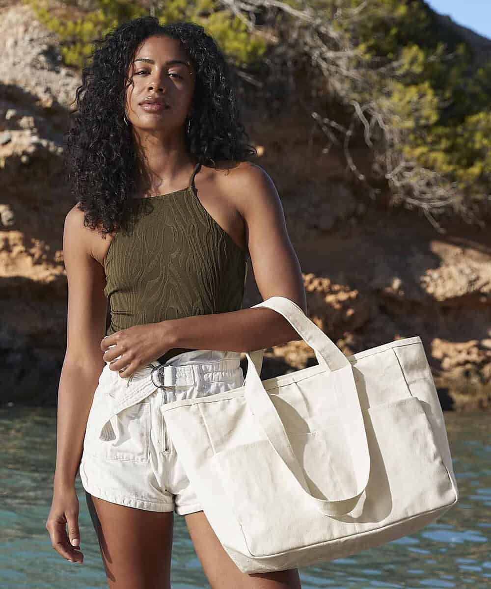 Spacious white canvas tote bag ideal for travel, shopping, and daily use.