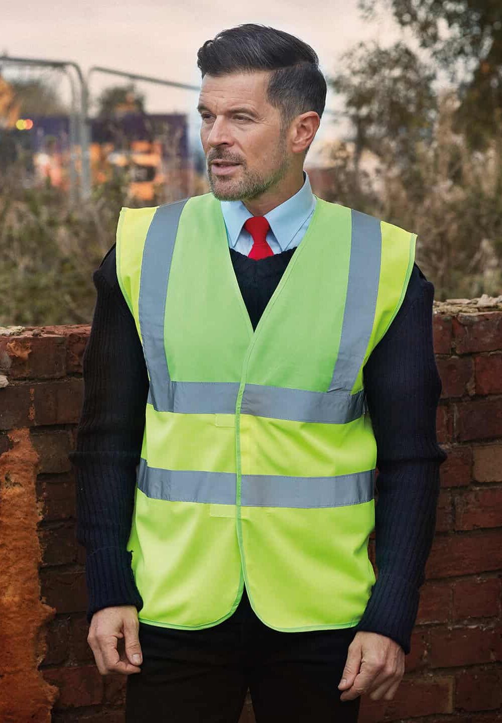 High visibility safety vest with reflective stripes for construction workers or site safety.