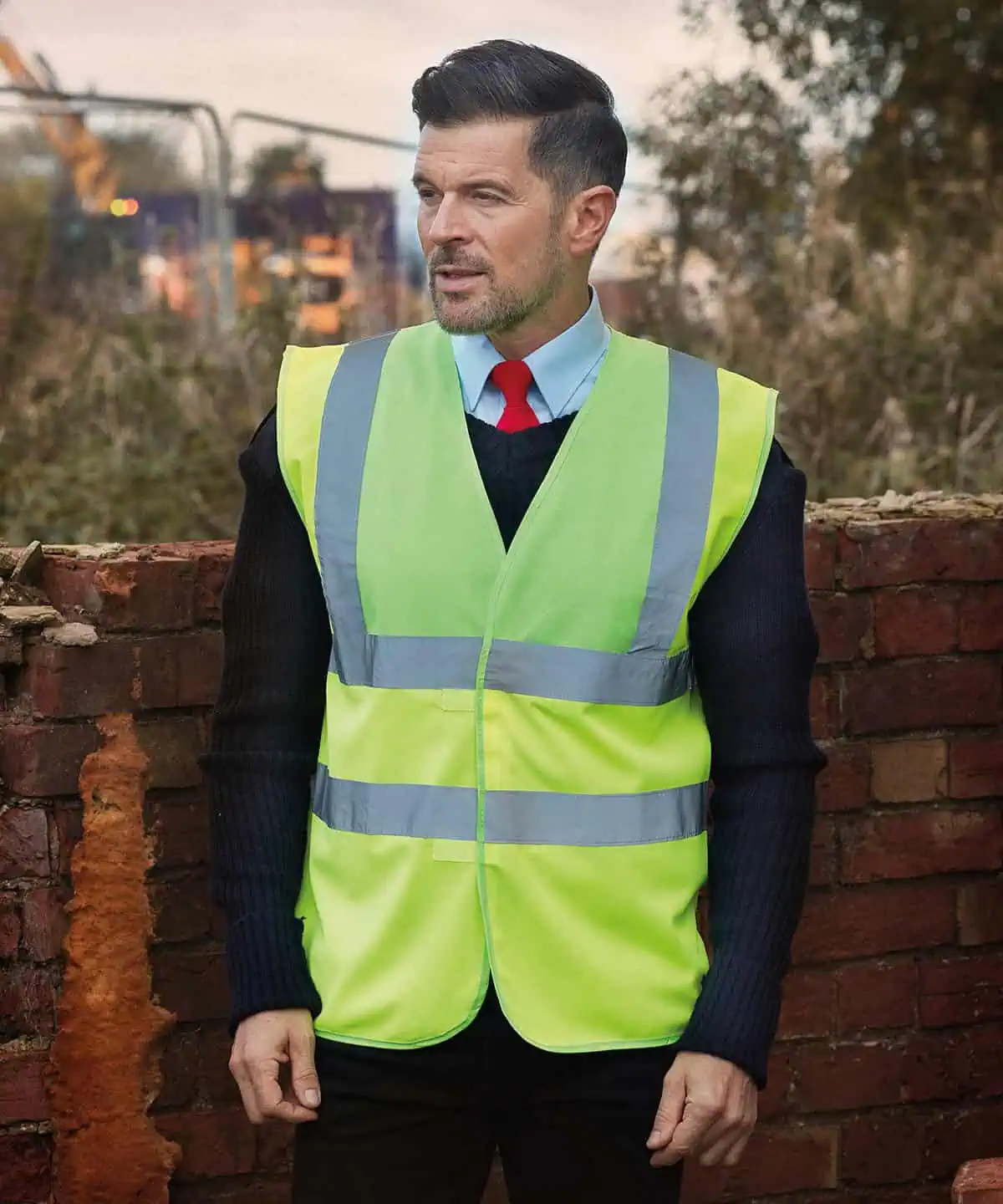 High visibility safety vest with reflective stripes for construction workers or site safety.
