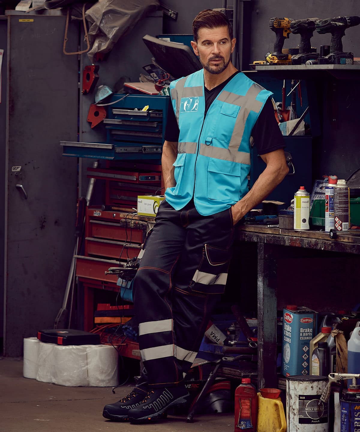 Workwear safety vest with reflective strips, suitable for industrial and construction environments. High visibility embroidered work clothing for workforce protection.