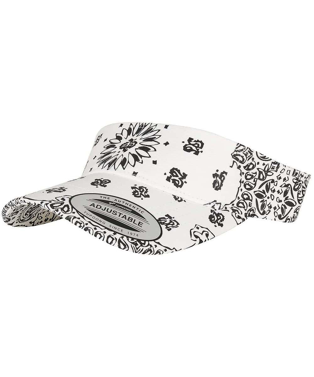 Visor with black and white floral and logo print, adjustable strap for a comfortable fit.