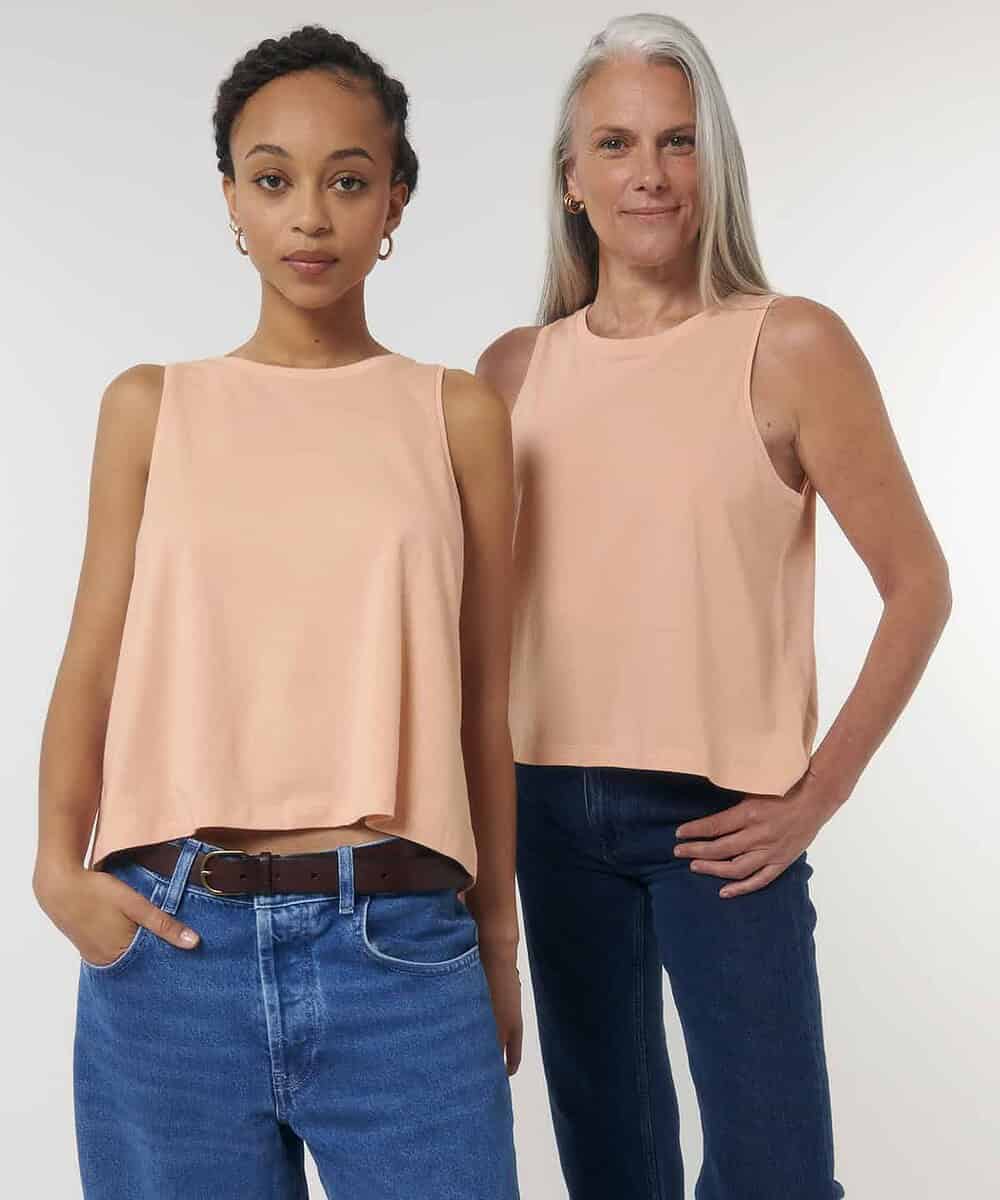 Embroidered women's crop tank top in soft peach, perfect for team uniforms or casual wear.